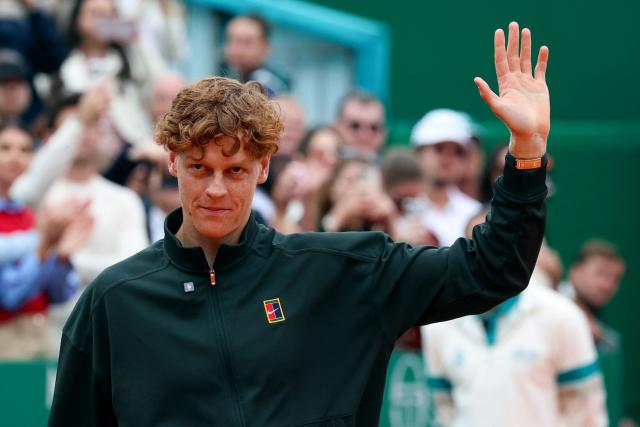 Italy's Jannik Sinner waves as he celebrates after winning against Spain's Carlos Alcaraz following their Monte Carlo ATP Masters Series Tournament final tennis match on Court Rainier III at the Monte-Carlo Country Club in Roquebrune-Cap-Martin, south-eastern France on April 12, 2026. (Photo by Valery HACHE / AFP)