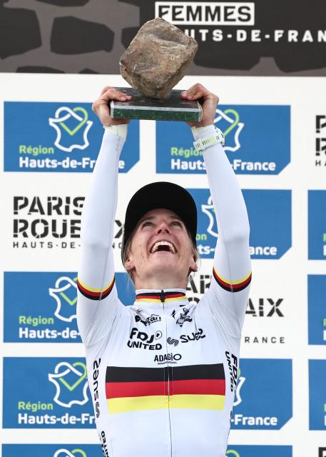 Winner FDJ United-SUEZ's German rider Franziska Koch celebrates on the podium of the 6th edition of the Women Paris-Roubaix one-day classic cycling race, 143.1 km between Denain and Roubaix, at the Vélodrome André-Pétrieux in Roubaix, northern France, on April 12, 2026. (Photo by Anne-Christine POUJOULAT / AFP)