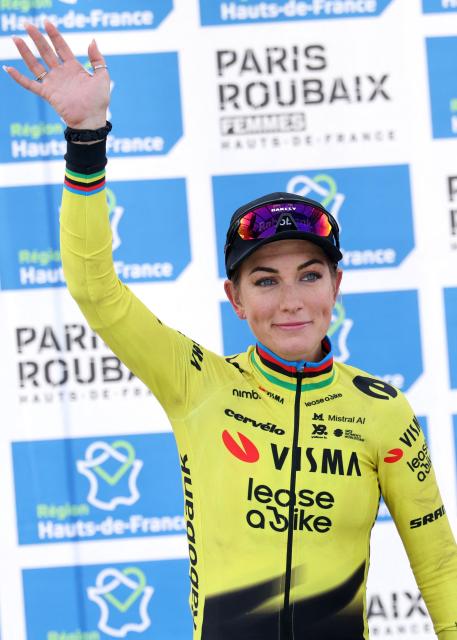 Team Visma - Lease a Bike's French rider Pauline Ferrand-Prévot celebrates on the podium of the 6th edition of the Women Paris-Roubaix one-day classic cycling race, 143.1 km between Denain and Roubaix, at the Vélodrome André-Pétrieux in Roubaix, northern France, on April 12, 2026. (Photo by Francois LO PRESTI / AFP)