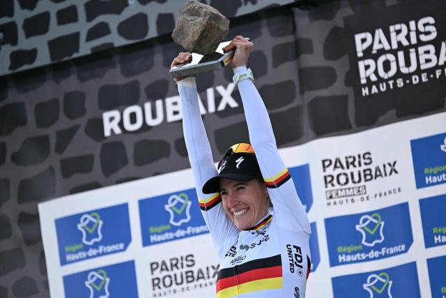 Winner FDJ United-SUEZ's German rider Franziska Koch celebrates on the podium of the 6th edition of the Women Paris-Roubaix one-day classic cycling race, 143.1 km between Denain and Roubaix, at the Vélodrome André-Pétrieux in Roubaix, northern France, on April 12, 2026. (Photo by NICOLAS TUCAT / AFP)