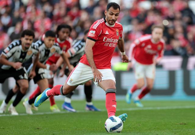 SL Benfica's Greek forward #14 Vangelis Pavlidis shoots a penalty kick during the Portuguese League football match between SL Benfica and CD Nacional da Madeira at Luz Stadium in Lisbon on April 12 , 2026. (Photo by PATRICIA DE MELO MOREIRA / AFP)