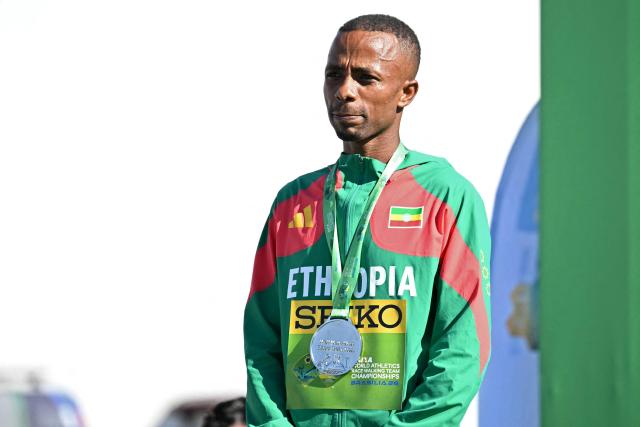 Ethiopia's Misgana Wakuma celebrates with his silver medal during the award ceremony of the World Athletics Race Walking Team Championships men's half-marathon, in Brasilia, on April 12, 2026. (Photo by Evaristo SA / AFP)