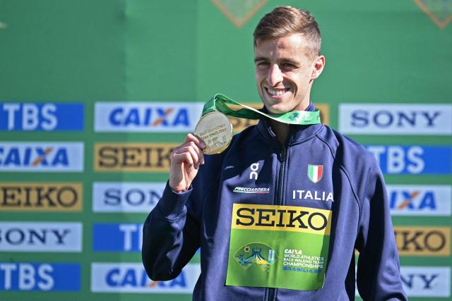 Italy's Francesco Fortunato celebrates with his gold medal during the award ceremony of the World Athletics Race Walking Team Championships men's half-marathon, in Brasilia, on April 12, 2026. (Photo by Evaristo SA / AFP)