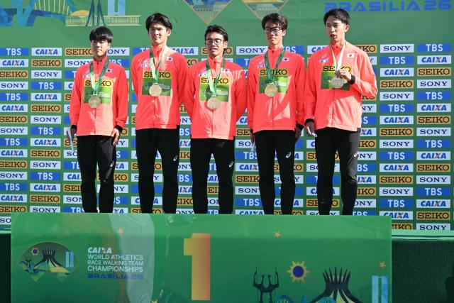 Japan's team members pose with their bronze medals during the award ceremony of the World Athletics Race Walking Team Championships men's team half-marathon, in Brasilia, on April 12, 2026. (Photo by Evaristo SA / AFP)