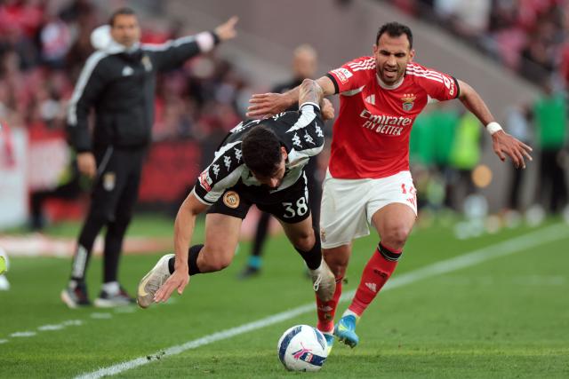 Nacional's Brazilian defender #38 Ze Vitor and SL Benfica's Greek forward #14 Vangelis Pavlidis fight for the ball during the Portuguese League football match between SL Benfica and CD Nacional da Madeira at Luz Stadium in Lisbon on April 12 , 2026. (Photo by PATRICIA DE MELO MOREIRA / AFP)
