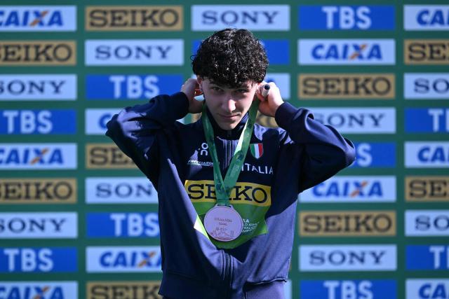 Italy's Alessio Coppola celebrates his bronze medal during the award ceremony of the World Athletics Race Walking Team Championships U20 men's 10km race, in Brasilia, on April 12, 2026. (Photo by Evaristo SA / AFP)