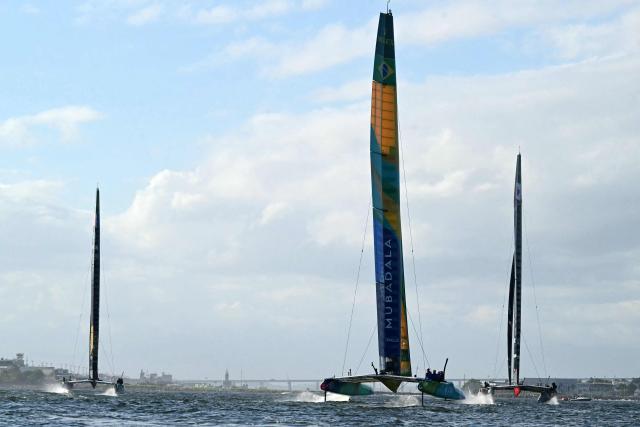Teams from Brazil (C), Canada (R) and France compete during race day two of the Rio 2026 SailGP in Guanabara Bay, Rio de Janeiro, Brazil, on April 12, 2026. (Photo by Pablo PORCIUNCULA / AFP)