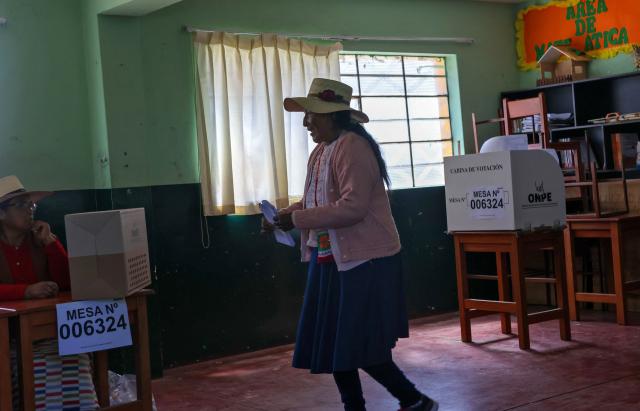 A peasant woman votes in the district of Chiguata, an agricultural area located some 25 kilometres from Arequipa, Peru on April 12, 2026, during general elections. Peruvians will elect a new president from a record field of 35 candidates to lead a country plagued by organized crime and chronic political instability. (Photo by Diego RAMOS / AFP)