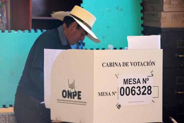 A man votes in the district of Chiguata, an agricultural area located some 25 kilometres from Arequipa, Peru on April 12, 2026, during general elections. Peruvians will elect a new president from a record field of 35 candidates to lead a country plagued by organized crime and chronic political instability. (Photo by Diego RAMOS / AFP)