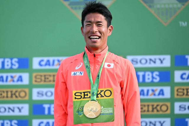 Japan's Katsuki Hayato celebrates his gold medal during the award ceremony of the World Athletics Race Walking Team Championships men's marathon, in Brasilia, on April 12, 2026. (Photo by Evaristo SA / AFP)