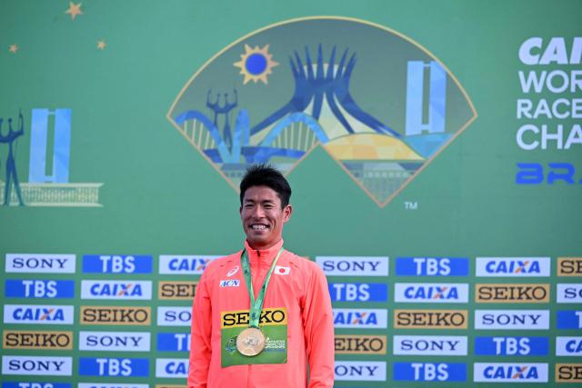 Japan's Katsuki Hayato celebrates his gold medal during the award ceremony of the World Athletics Race Walking Team Championships men's marathon, in Brasilia, on April 12, 2026. (Photo by Evaristo SA / AFP)