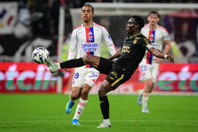 Lorient's Cameroonian midfielder #62 Arthur Avom Ebong (C) controls the ball during the French L1 football match between Olympique Lyonnais (OL) and FC Lorient at the Groupama Stadium in Decines-Charpieu, central-eastern France, on April 12, 2026. (Photo by OLIVIER CHASSIGNOLE / AFP)