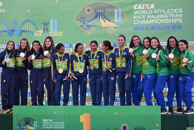 Ecuador, Italy and Brazil's's team members celebrate their gold, silver, and bronze medals respectively during the award ceremony of the World Athletics Race Walking Team Championships women's team marathon, in Brasilia, on April 12, 2026. (Photo by Evaristo SA / AFP)