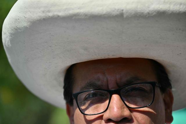 Peru's presidential candidate Roberto Sanchez of the Juntos por el Peru party speaks with reporters as he arrives at a polling station in Lima on April 12, 2026, during the general election. Hours-long delays marred Peru's presidential and legislative elections on Sunday, as voters sought to end political chaos that has seen a string of presidents ousted or jailed. (Photo by Luis ROBAYO / AFP)