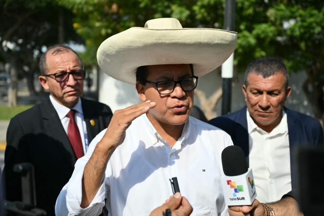 Peru's presidential candidate Roberto Sanchez of the Juntos por el Peru party speaks with reporters as he arrives at a polling station in Lima on April 12, 2026, during the general election. Hours-long delays marred Peru's presidential and legislative elections on Sunday, as voters sought to end political chaos that has seen a string of presidents ousted or jailed. (Photo by Luis ROBAYO / AFP)