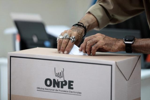 A man casts his ballot during the presidential election at a polling station in Lima on April 12, 2026. Hours-long delays marred Peru's presidential and legislative elections on Sunday, as voters sought to end political chaos that has seen a string of presidents ousted or jailed. (Photo by Connie FRANCE / AFP)