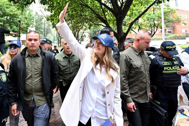 (FILES) Right-wing presidential candidate Paloma Valencia, from the Centro Democratico party, surrounded by security guards, greets supporters during a campaign rally in Bogota on March 26, 2026. Colombian government boosted the security of the opposition presidential candidate Valencia, after she reported death threats less than two months before the Presidential election. (Photo by Daniel MUNOZ / AFP)