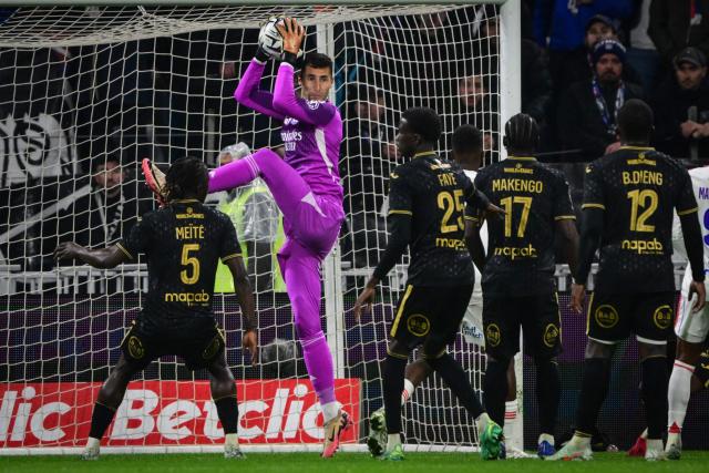 Lyon’s Slovak goalkeeper #01 Dominik Greif (2L) catches the ball during the French L1 football match between Olympique Lyonnais (OL) and FC Lorient at the Groupama Stadium in Decines-Charpieu, central-eastern France, on April 12, 2026. (Photo by OLIVIER CHASSIGNOLE / AFP)