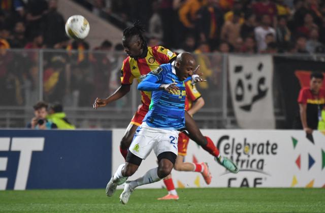 Esperande de Tunis Mauritanian defender #23 Ibrahima Keita (L) and Sundowns's South African defender #25 Khuliso Mudau (R) fight for the ball during the CAF Champions League semi-final first leg football match between Esperance Sportive de Tunis (TUN) and Mamelodi Sundowns (RSA) at the Hammadi Agrebi Stadium in Rades on April 12, 2026. (Photo by FETHI BELAID / AFP)