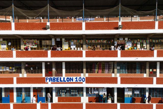 Aerial view of Fe y Alegria 65 school polling station in Pamplona Alta, San Juan de Miraflores district on the outskirts of Lima on April 12, 2026. Peruvians head to the polls to elect its ninth president in a decade, from a record field of 35 candidates, with crime-weary voters seemingly poised to extend the tide of conservative governments sweeping Latin America. (Photo by Ernesto BENAVIDES / AFP)
