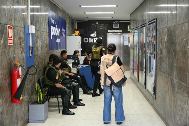 Members of Peru’s police force stand guard inside the National Office of Electoral Processes (ONPE) in Lima on April 12, 2026, during the general election. Hours-long delays marred Peru's presidential and legislative elections on April 12, as voters sought to end political chaos that has seen a string of presidents ousted or jailed. (Photo by Luis ROBAYO / AFP)