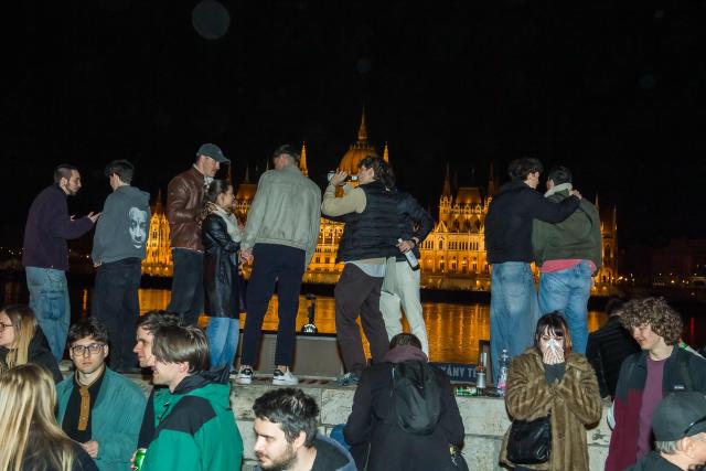 People celebrate in the streets after Hungarian Prime Minister Viktor Orban conceded defeat to Peter Magyar, leader of the pro-European conservative TISZA party, in Budapest, on April 12, 2026. Polls closed in Hungary's parliamentary election, with turnout reaching a record high in the crunch vote that sees nationalist Prime Minister Viktor Orban's 16-year stint in power face an unprecedented challenge from conservative political newcomer Peter Magyar. (Photo by Ferenc ISZA / AFP)