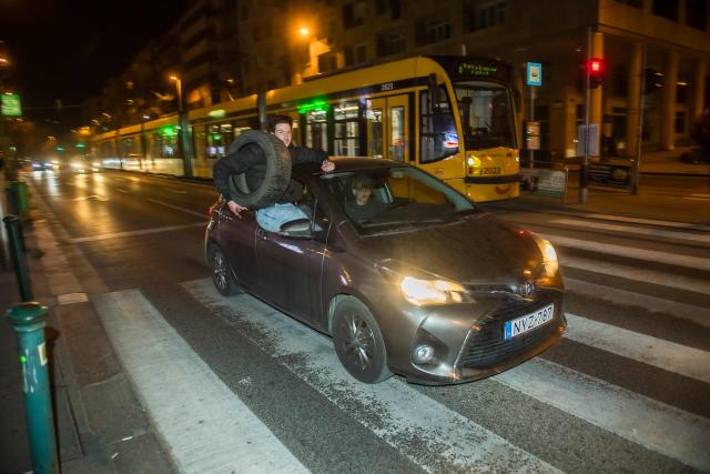 People celebrate in the streets after Hungarian Prime Minister Viktor Orban conceded defeat to Peter Magyar, leader of the pro-European conservative TISZA party, in Budapest, on April 12, 2026. Polls closed in Hungary's parliamentary election, with turnout reaching a record high in the crunch vote that sees nationalist Prime Minister Viktor Orban's 16-year stint in power face an unprecedented challenge from conservative political newcomer Peter Magyar. (Photo by Ferenc ISZA / AFP)