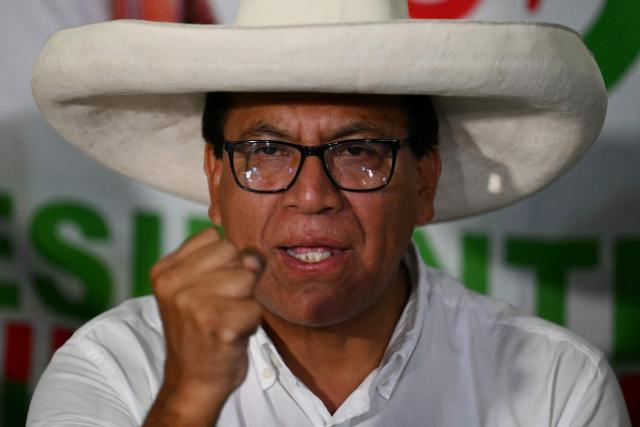 Peru's presidential candidate Roberto Sanchez of the Juntos por el Peru party, gestures as he gives a speech following the first results of the presidential election in Lima on April 12, 2026. Right-wing candidate Keiko Fujimori led exit polls following Peru's troubled presidential election on April 12, 2026, but failed to avoid a runoff after a tight vote marred by irregularities and a police raid on the country's election authority. (Photo by Luis ROBAYO / AFP)