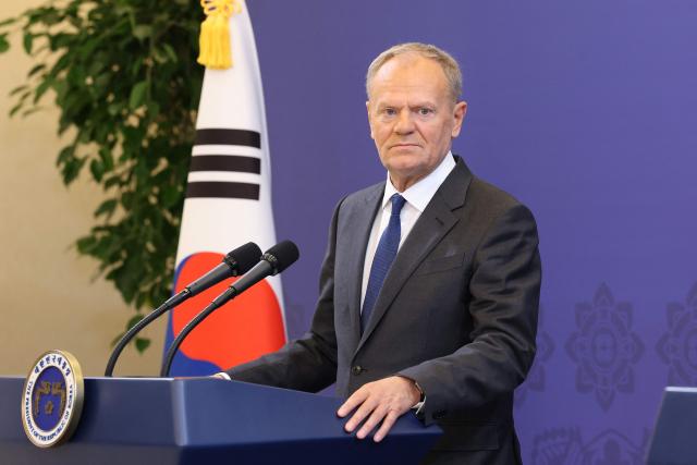 Poland's Prime Minister Donald Tusk speaks during a joint press conference with South Korean President Lee Jae Myung at the presidential Blue House in Seoul on April 13, 2026.  (Photo by Chung Sung-Jun / POOL / AFP)