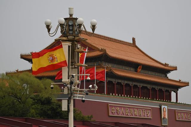 The national flags of Spain and China hang near Tiananmen Gate during a visit by Spain's Prime Minister Pedro Sanchez in Beijing on April 13, 2026. (Photo by Pedro PARDO / AFP)