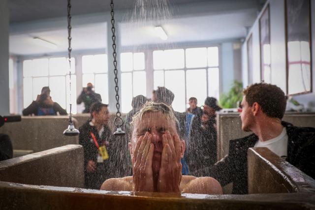 TOPSHOT - (FILES) UAE Team Emirates XRG's Slovenian rider Tadej Pogacar takes a shower at the end of the 123rd edition of the Paris-Roubaix one-day classic cycling race, 258.3 km between Compiègne and Roubaix, at the Vélodrome André-Pétrieux in Roubaix, northern France, on April 12, 2026. (Photo by Anne-Christine POUJOULAT / AFP)