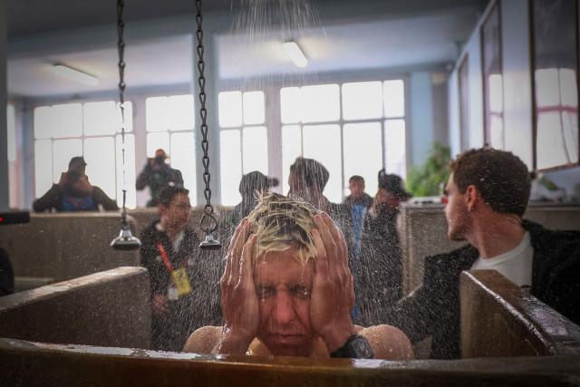 (FILES) UAE Team Emirates XRG's Slovenian rider Tadej Pogacar takes a shower at the end of the 123rd edition of the Paris-Roubaix one-day classic cycling race, 258.3 km between Compiègne and Roubaix, at the Vélodrome André-Pétrieux in Roubaix, northern France, on April 12, 2026. (Photo by Anne-Christine POUJOULAT / AFP)