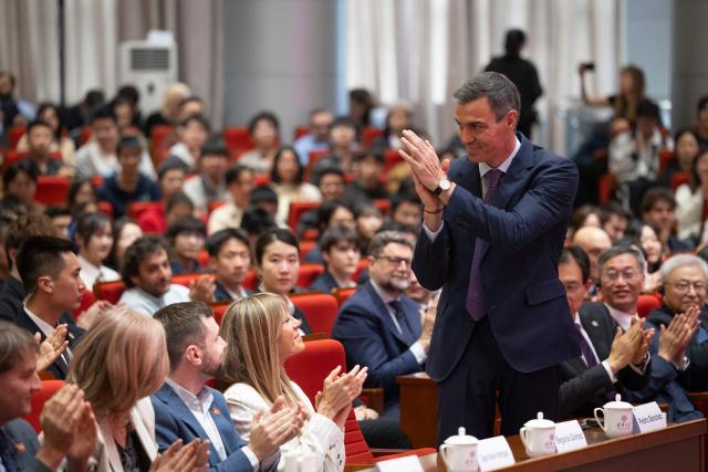 Spain's Prime Minister Pedro Sanchez applauds after his speech at Tsinghua University in Beijing on April 13, 2026. Sanchez called China's trade imbalance with the European Union "unsustainable" on April 13, as he began a three-day visit to Beijing where he hopes to strengthen economic ties. (Photo by ANDRES MARTINEZ CASARES / POOL / AFP)