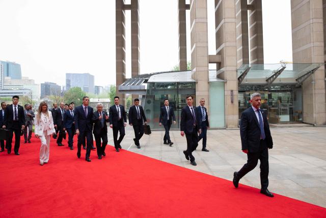 Spanish Prime Minister Pedro Sanchez (centre, L) and his wife Begona Gomez arrive to the University of Chinese Academy of Sciences in Beijing on April 13, 2026. Sanchez called China's trade imbalance with the European Union "unsustainable" on April 13, as he began a three-day visit to Beijing where he hopes to strengthen economic ties. (Photo by ANDRES MARTINEZ CASARES / POOL / AFP)