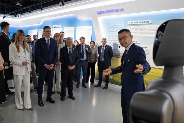 Spain's Prime Minister Pedro Sanchez (2nd L) and his wife Begona Gomez visit to the University of Chinese Academy of Sciences in Beijing on April 13, 2026. Sanchez called China's trade imbalance with the European Union "unsustainable" on April 13, as he began a three-day visit to Beijing where he hopes to strengthen economic ties. (Photo by ANDRES MARTINEZ CASARES / POOL / AFP)