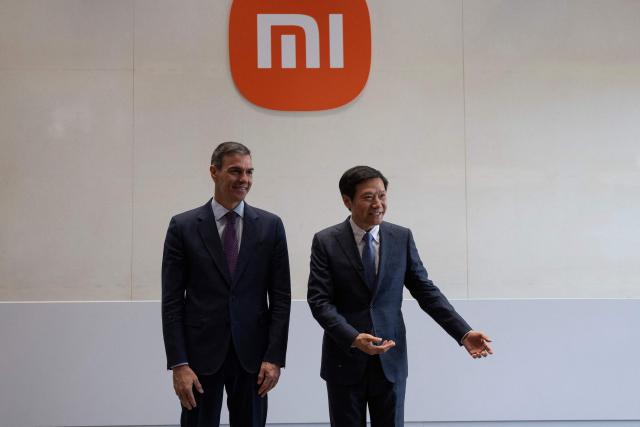 Spain's Prime Minister Pedro Sanchez (L) and Founder, Chairman & CEO of Xiaomi, Lei Jun, pose for a photo at the Xiaomi headquarters Beijing on April 13, 2026. Sanchez called China's trade imbalance with the European Union "unsustainable" on April 13, as he began a three-day visit to Beijing where he hopes to strengthen economic ties. (Photo by ANDRES MARTINEZ CASARES / POOL / AFP)