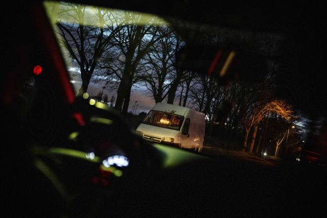 (FILES) A sex worker waits for a client in her van in the Bois de Vincennes, eastern Paris, on March 30, 2024. A 2016 law in France criminalised the purchase of sexual services, reclassifying sex workers as victims and making clients liable to a fine of 1,500 euros. Ten years after the law, the organisations Federation Parapluie rouge, Amnesty International, Acceptess-T and the NousToutes collective are calling in a private member’s bill (PPL) to decriminalise sex work. (Photo by JULIEN DE ROSA / AFP)