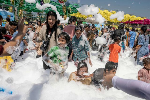 People play with soap suds during celebrations for Myanmar's Buddhist New Year water festival, also known as Thingyan, in Yangon on April 13, 2026. (Photo by Sai Aung MAIN / AFP)