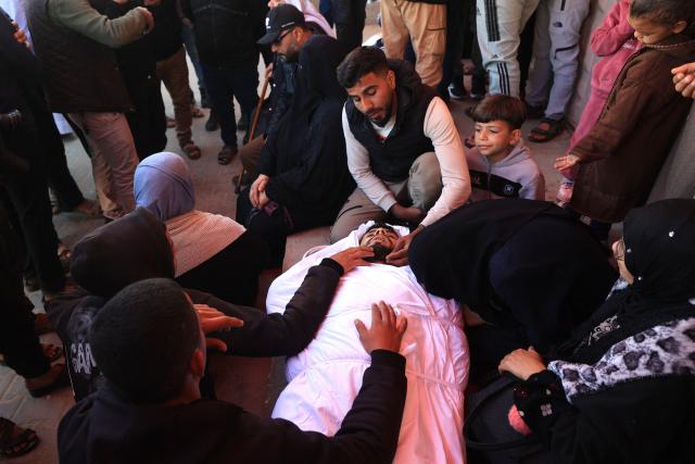 Mourners react during the funeral of Palestinians who, according to a medic, were killed the night before in an Israeli strike at al-Aqsa Martyrs Hospital in Deir al Balah, central Gaza Strip, on April 13, 2026. Both Israel and Hamas have accused each other of breaching the US-backed truce, which has largely halted the two-year war that devastated the enclave of 2.2 million. A delegation from Hamas was set to hold talks with Egyptian mediators in Cairo on April 12, 2026, to address alleged Israeli violations of the Gaza ceasefire, according to two officials from the Palestinian group. (Photo by Eyad Baba / AFP)
