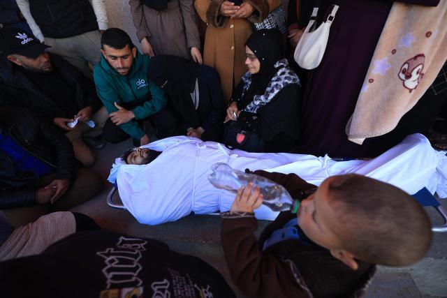 Mourners react during the funeral of Palestinians who, according to a medic, were killed the night before in an Israeli strike at al-Aqsa Martyrs Hospital in Deir al Balah, central Gaza Strip, on April 13, 2026. Both Israel and Hamas have accused each other of breaching the US-backed truce, which has largely halted the two-year war that devastated the enclave of 2.2 million. A delegation from Hamas was set to hold talks with Egyptian mediators in Cairo on April 12, 2026, to address alleged Israeli violations of the Gaza ceasefire, according to two officials from the Palestinian group. (Photo by Eyad Baba / AFP)