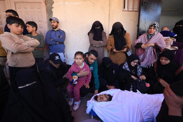 Mourners react during the funeral of Palestinians who, according to a medic, were killed the night before in an Israeli strike at al-Aqsa Martyrs Hospital in Deir al Balah, central Gaza Strip, on April 13, 2026. Both Israel and Hamas have accused each other of breaching the US-backed truce, which has largely halted the two-year war that devastated the enclave of 2.2 million. A delegation from Hamas was set to hold talks with Egyptian mediators in Cairo on April 12, 2026, to address alleged Israeli violations of the Gaza ceasefire, according to two officials from the Palestinian group. (Photo by Eyad Baba / AFP)