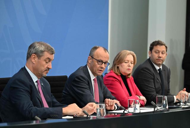 (L-R) Bavaria's State Premier and leader of the conservative Christian Social Union (CSU) Markus Soeder, German Chancellor Friedrich Merz of the conservative Christian Democratic Union (CDU), German Minister for Labour and Social Affairs Baerbel Bas from the social democratic SPD party, and German Finance Minister and Vice Chancellor Lars Klingbeil (SPD) attend a press briefing on the results of overnight coalition committee consultations, on April 13, 2026 at the Chancellery in Berlin. Chancellor Friedrich Merz said that Germany would cut petrol and diesel taxes for two months to provide relief to households and businesses hit by the energy shock during the Middle East war. (Photo by RALF HIRSCHBERGER / AFP)