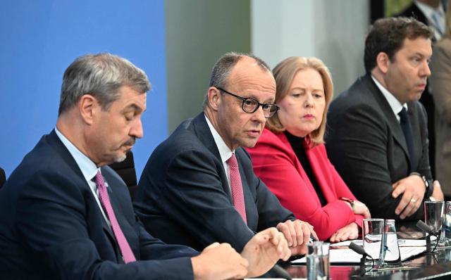 (L-R) Bavaria's State Premier and leader of the conservative Christian Social Union (CSU) Markus Soeder, German Chancellor Friedrich Merz of the conservative Christian Democratic Union (CDU), German Minister for Labour and Social Affairs Baerbel Bas from the social democratic SPD party, and German Finance Minister and Vice Chancellor Lars Klingbeil (SPD) attend a press briefing on the results of overnight coalition committee consultations, on April 13, 2026 at the Chancellery in Berlin. Chancellor Friedrich Merz said that Germany would cut petrol and diesel taxes for two months to provide relief to households and businesses hit by the energy shock during the Middle East war. (Photo by RALF HIRSCHBERGER / AFP)