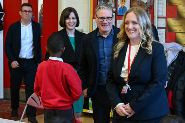 Britain's Prime Minister Keir Starmer (2nd R) arrives with Britain's Education Secretary Bridget Phillipson (2nd L) and Manchester Mayor Andy Burnham (back L) to meet with school children during a visit to a primary school in Ashton-under-Lyne, Greater Manchester, north-west England on April 13, 2026. (Photo by Paul ELLIS / POOL / AFP)