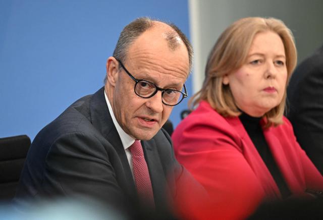 (L-R) German Chancellor Friedrich Merz and German Minister for Labour and Social Affairs Baerbel Bas (SPD) attend a press briefing on the results of their overnight coalition committee consultations, on April 13, 2026 at the Chancellery in Berlin. Chancellor Friedrich Merz said that Germany would cut petrol and diesel taxes for two months to provide relief to households and businesses hit by the energy shock during the Middle East war. (Photo by RALF HIRSCHBERGER / AFP)