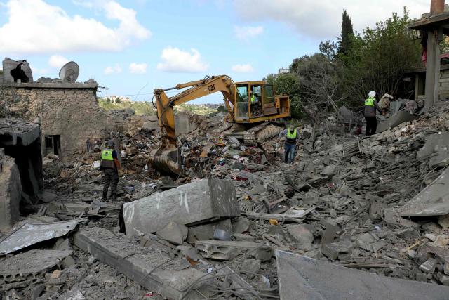 Lebanese first responders search for survivors in the aftermath of an Israeli airstrike that targeted the southern Lebanese village of Maaroub on April 13, 2016. Lebanon was drawn into the Middle East war on March 2 when Tehran-backed militant group Hezbollah launched attacks on Israel to avenge the killing of the Iranian leader. Israel has responded with broad strikes across Lebanon and a ground offensive. (Photo by Kawnat HAJU / AFP)