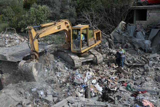 Lebanese first responders search for survivors in the aftermath of an Israeli airstrike that targeted the southern Lebanese village of Maaroub on April 13, 2016. Lebanon was drawn into the Middle East war on March 2 when Tehran-backed militant group Hezbollah launched attacks on Israel to avenge the killing of the Iranian leader. Israel has responded with broad strikes across Lebanon and a ground offensive. (Photo by Kawnat HAJU / AFP)