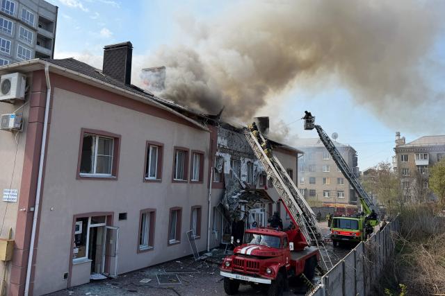 Ukrainian rescuers work to extinguish a fire in a damaged building following an air attack in Zaporizhzhia on April 13, 2026, amid the Russian invasion of Ukraine. Ukraine and Russia renewed overnight drone strikes on April 13, after the end of a 32-hour Orthodox Easter truce marred by accusations of mass violations, both countries said. (Photo by Darya NAZAROVA / AFP)