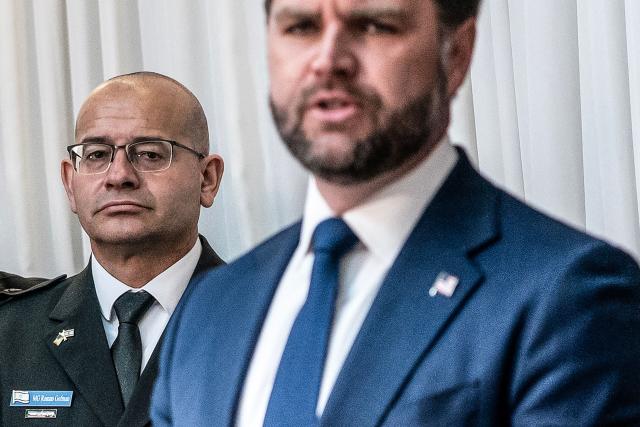 (FILES) Major General Roman Gofman (L) listens as US Vice President JD Vance as they meet with Israel's Prime Minister at his office in Jerusalem, on October 22, 2025. Israel's Prime Minister formally appointed Major General Roman Gofman, an army officer with no prior intelligence background, as the new chief of the countrys foreign intelligence agency, the Mossad, on April 12, 2026. Gofman will assume the role on June 2, 2026, when the current Mossad director completes his five-year term. (Photo by Nathan HOWARD / POOL / AFP)