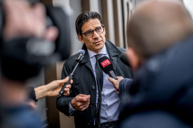 One of the plaintiff's lawyer Gilles-Antoine Hofstetter speaks to journalist prior to the hearing of the Mayor of Crans-Montana Nicolas Feraud as part of the investigation over the fire that broke out in the bar "Le Constellation" during New Year celebrations, claiming 41 lives, most of whom were teenagers, and injuring 115 more, in Sion, western Switzerland, on April 13, 2026. (Photo by Fabrice COFFRINI / AFP)